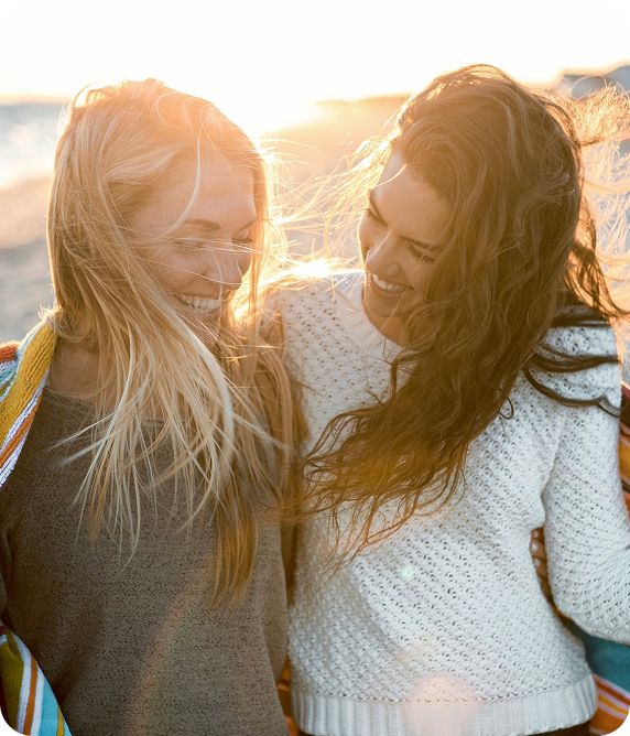 Two friends smiling together outdoors